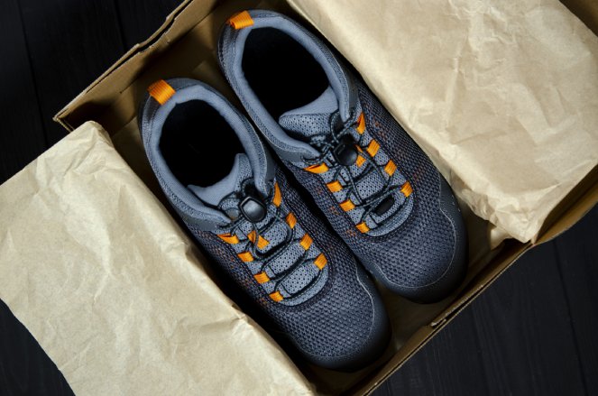 New sports shoes for sports and tourism lies in a shoe box. Apparel and Footwear supply chain