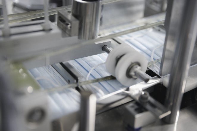 Medical mask in manufacturing machine in production line Healthcare supplies